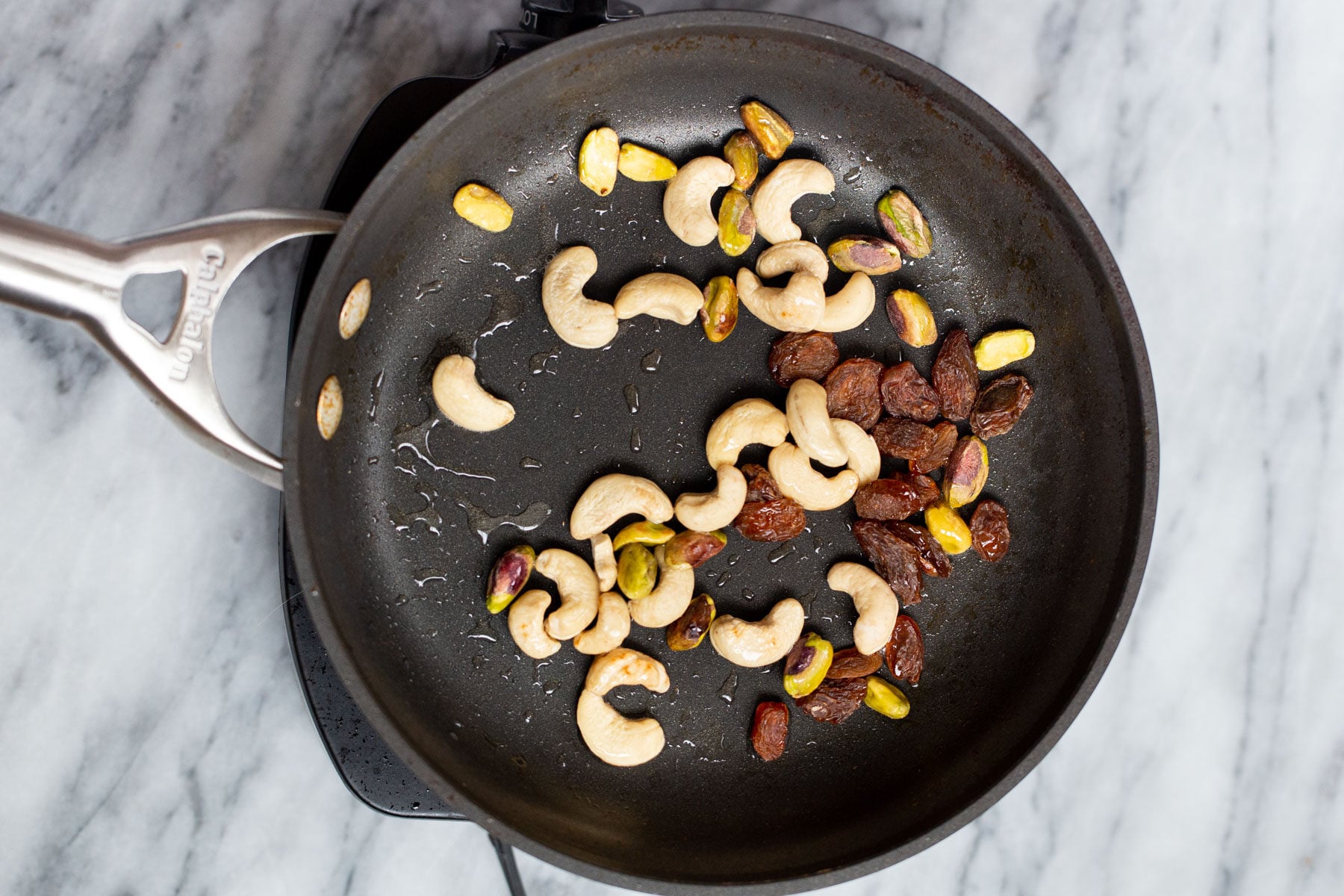 Navratan Korma a black skillet with toasted nuts