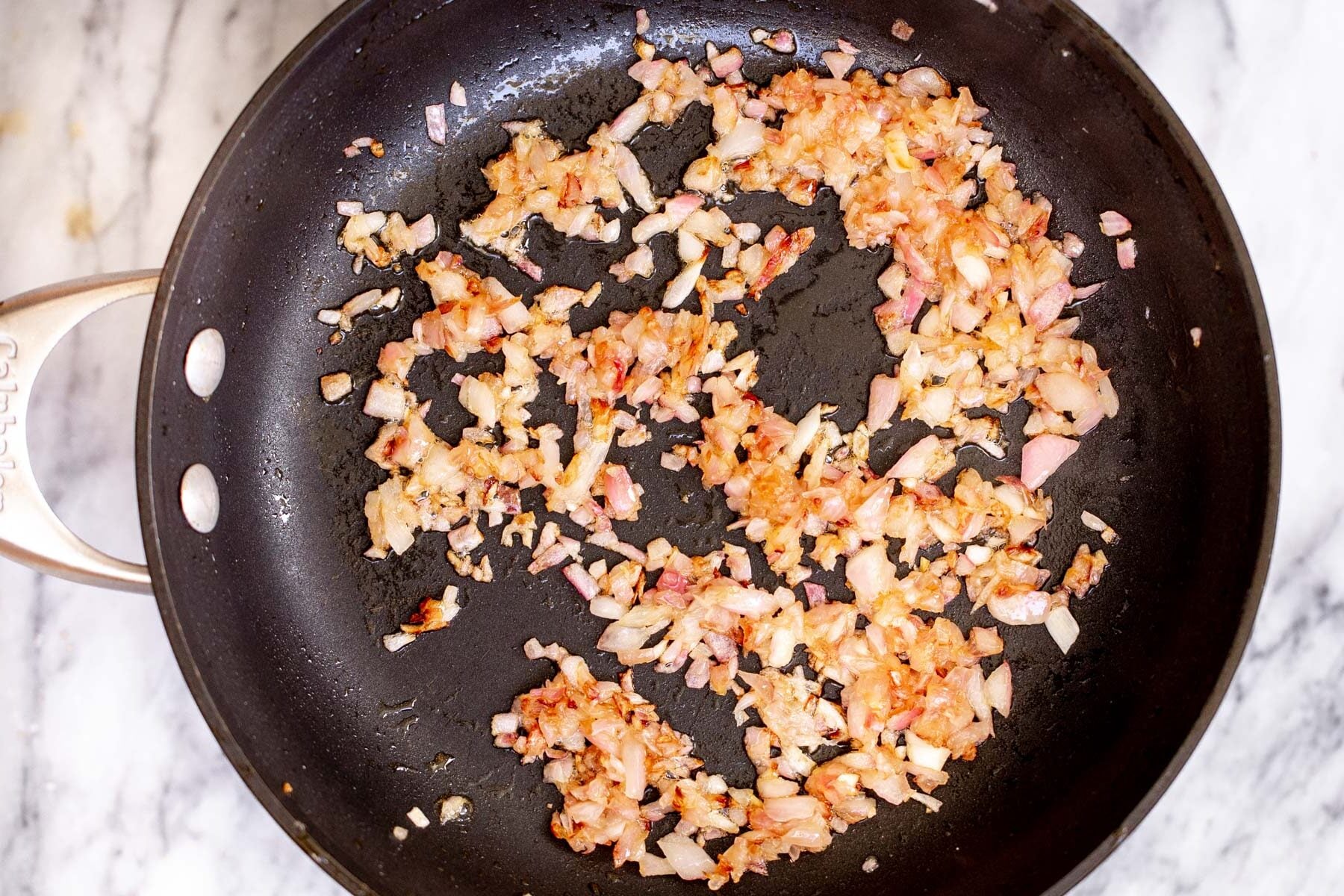 fried diced onions in a skillet