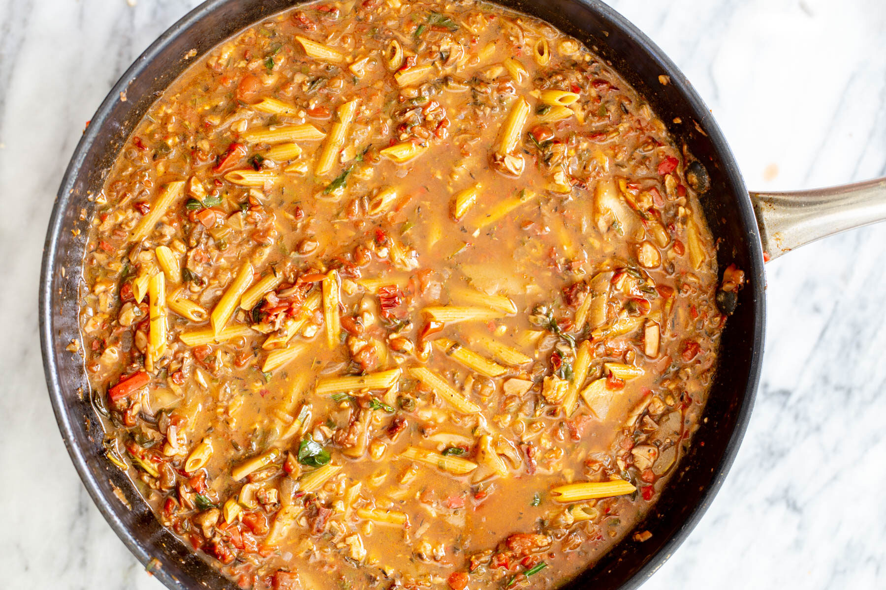 sauteeing pan with pasta and veggie ragu