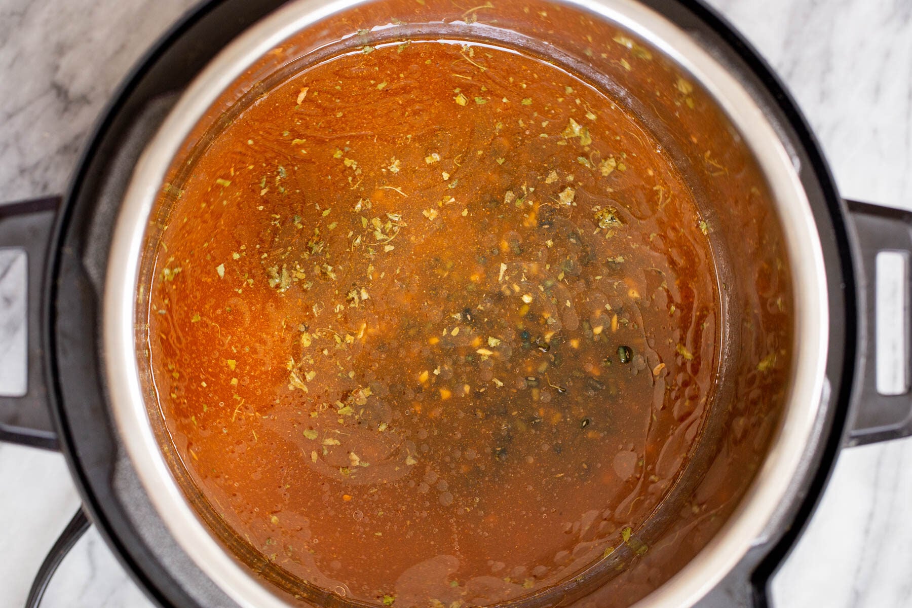 Black gram cooking with spices and tomato in an instant pot