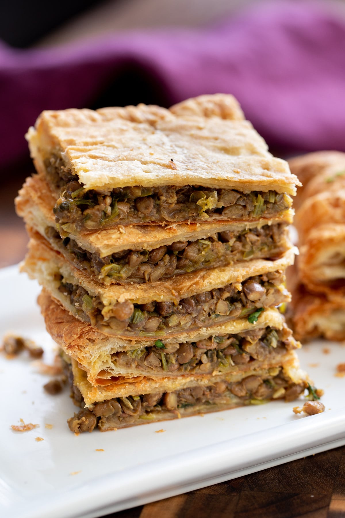 vegan sambusa pie squares stacked on a plate 