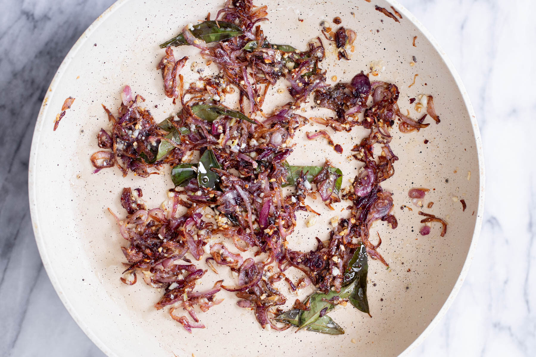fried onion and garlic in a sauteeing pan