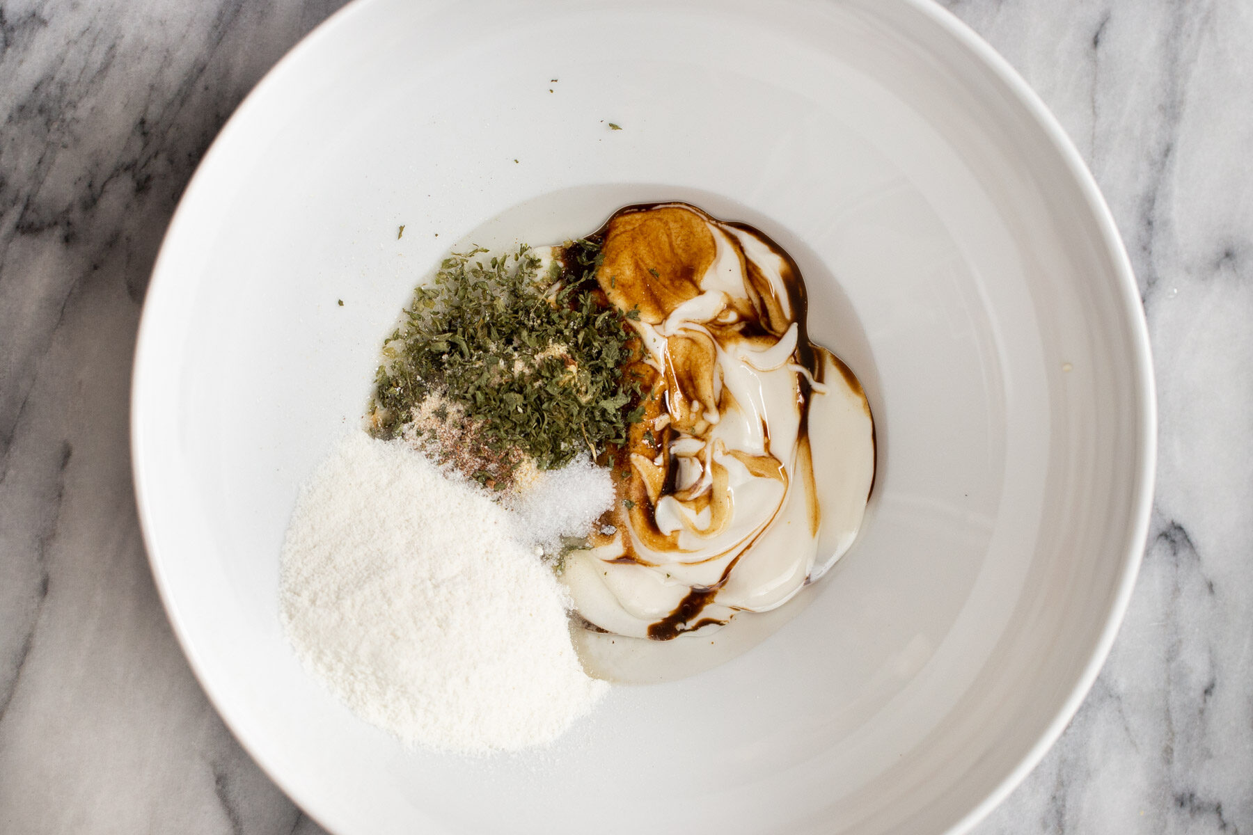 mushroom marinade ingredients in a white bowl