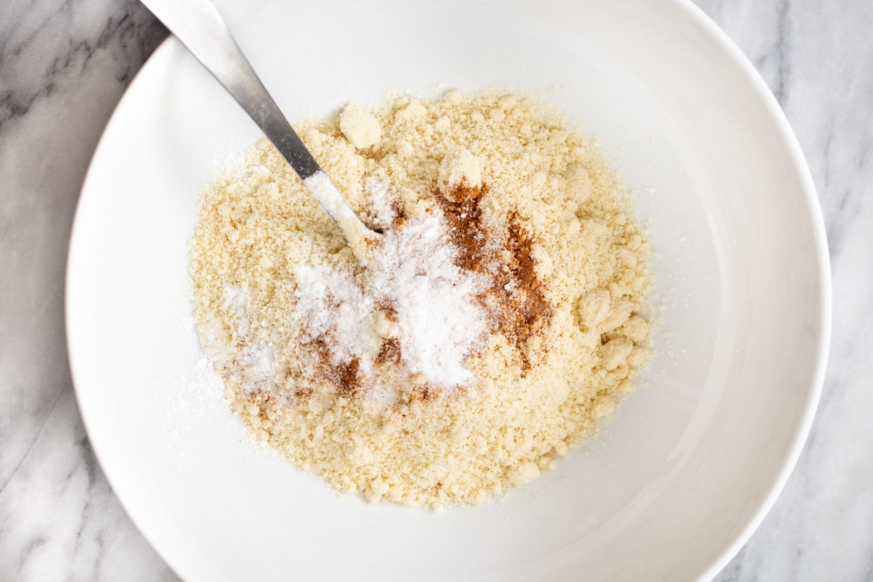 dry ingredients for vegan snickerdoodles in a white bowl