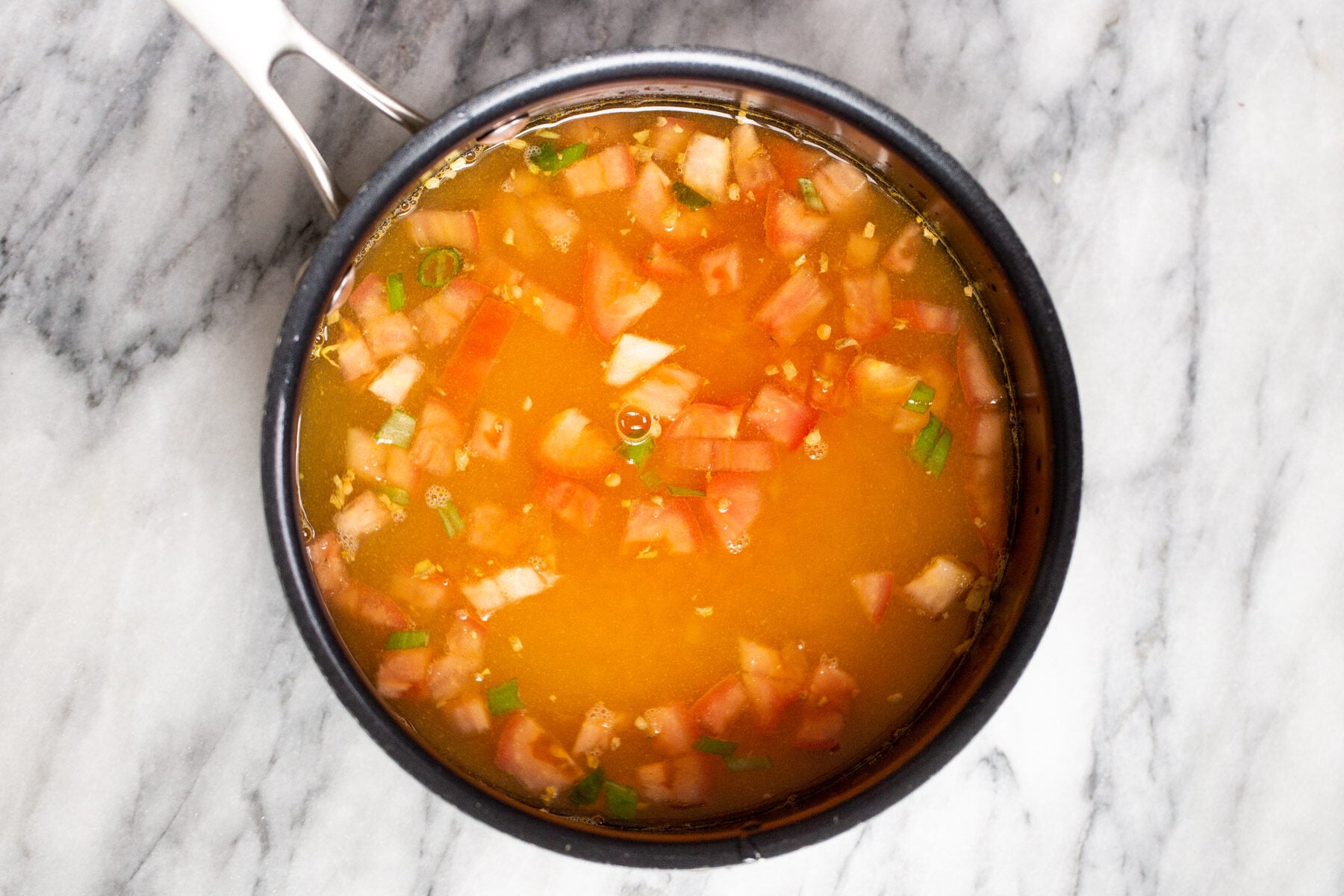 a pot with tomatoes and red lentils