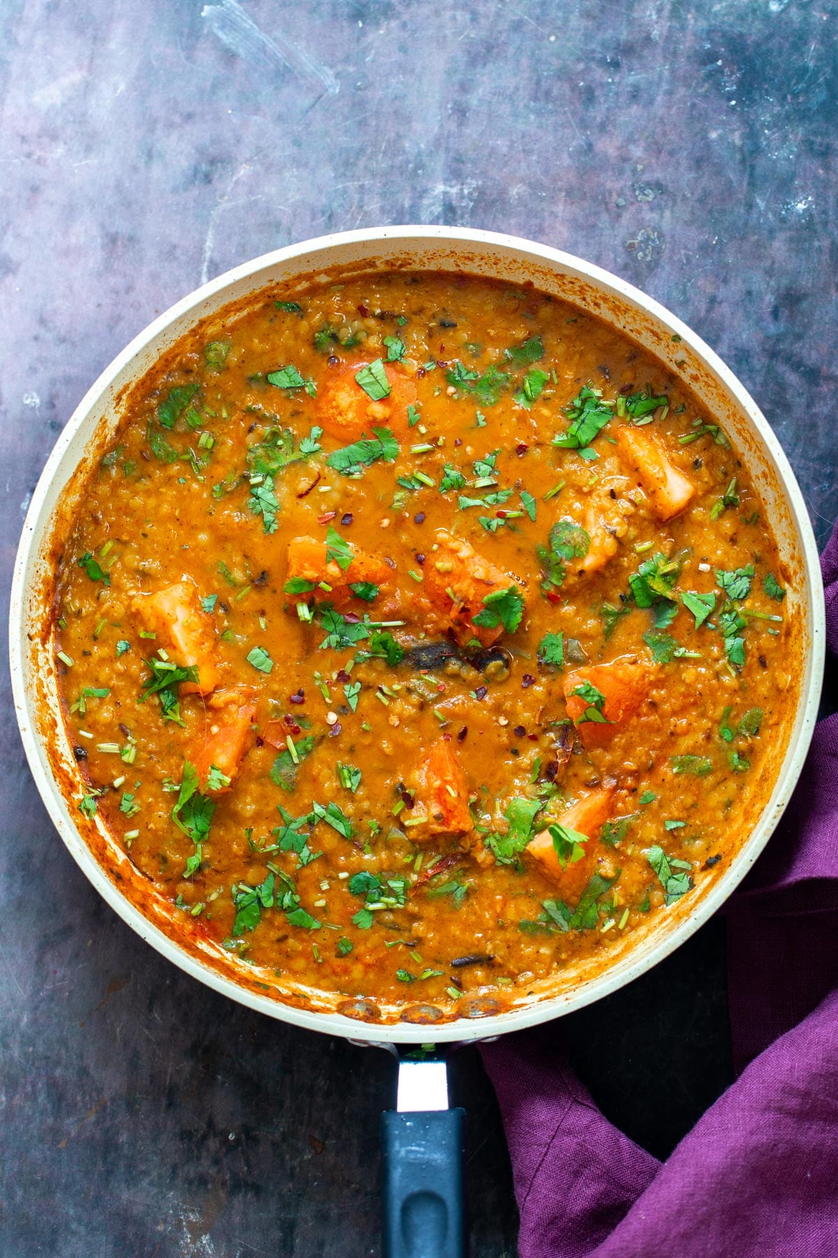 a pan with vegan butter dal sprinkled with cilantro