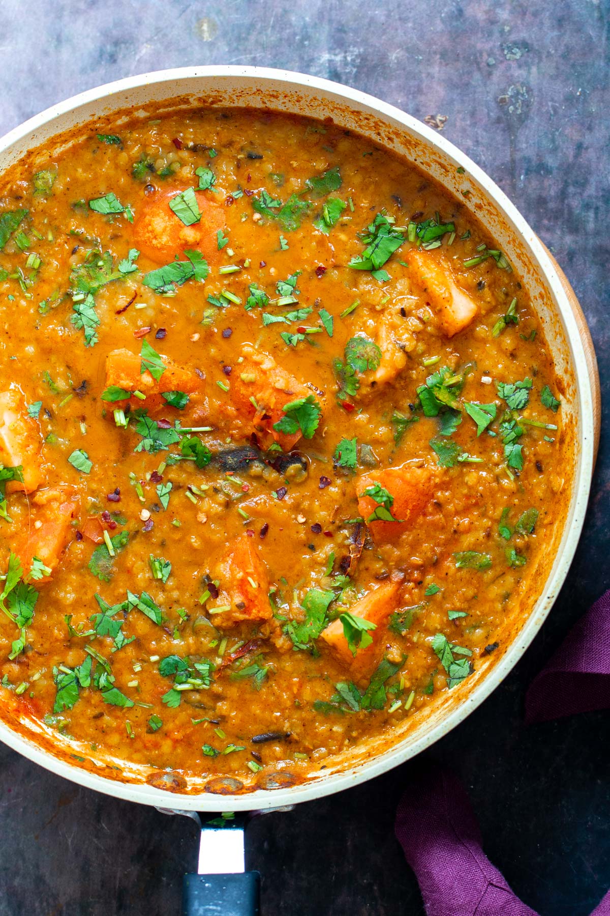 a pan with vegan butter dal sprinkled with cilantro