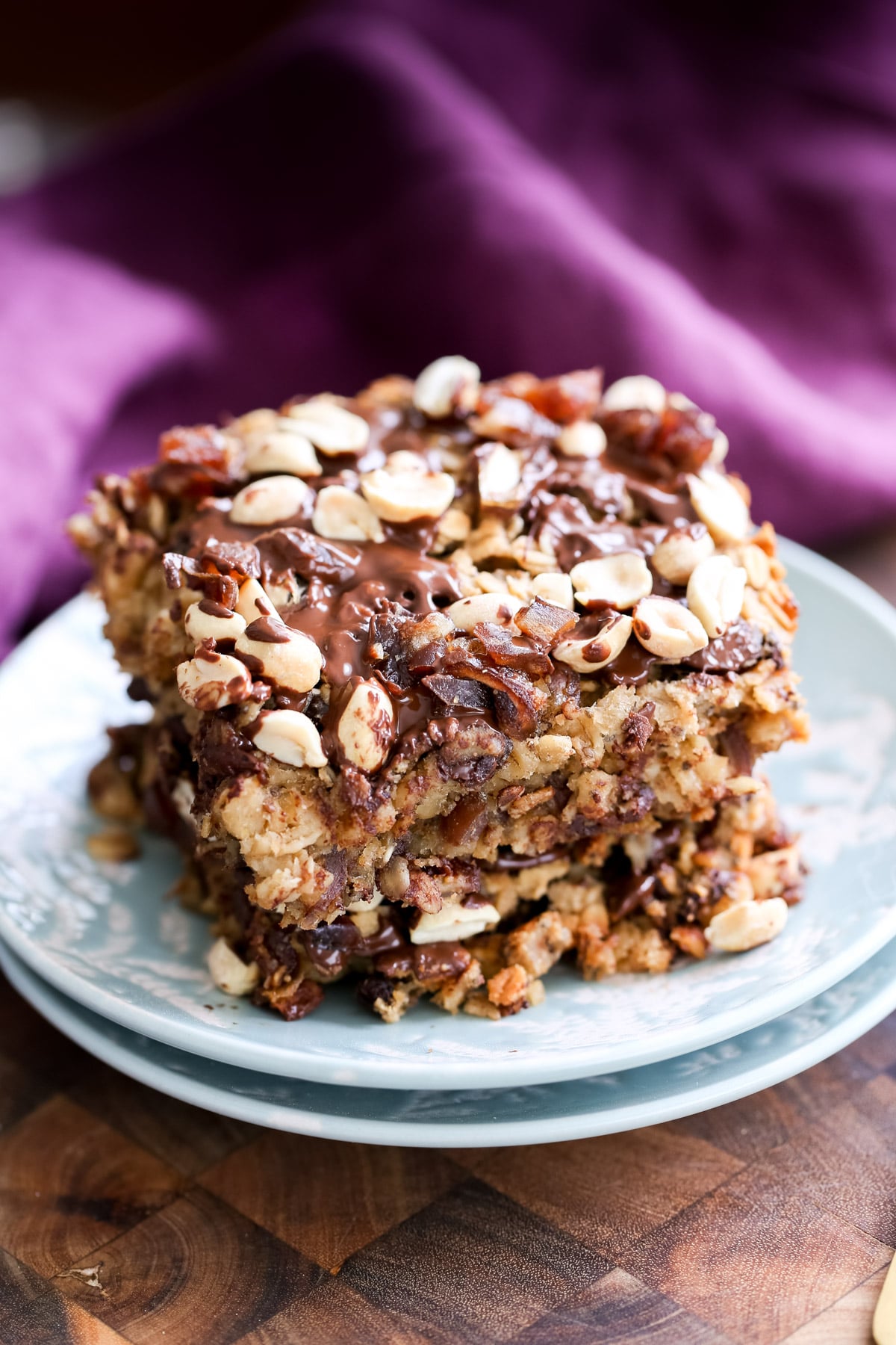 snickers baked oatmeal two stacked squares of vegan snickers baked oatmeal