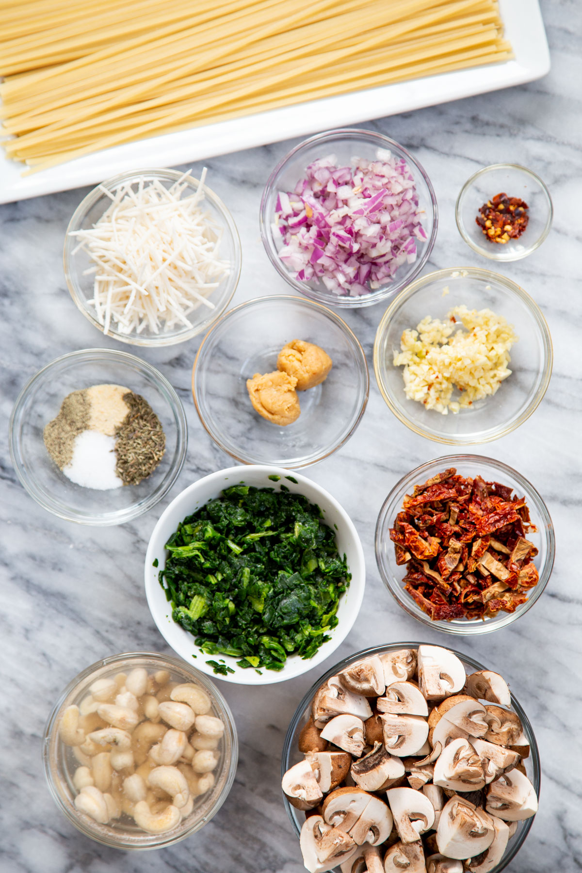 ingredients needed for making creamy vegan mushroom pasta with sundried tomatoes