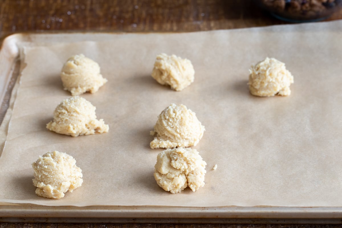 cookie dough balls on a baking sheet