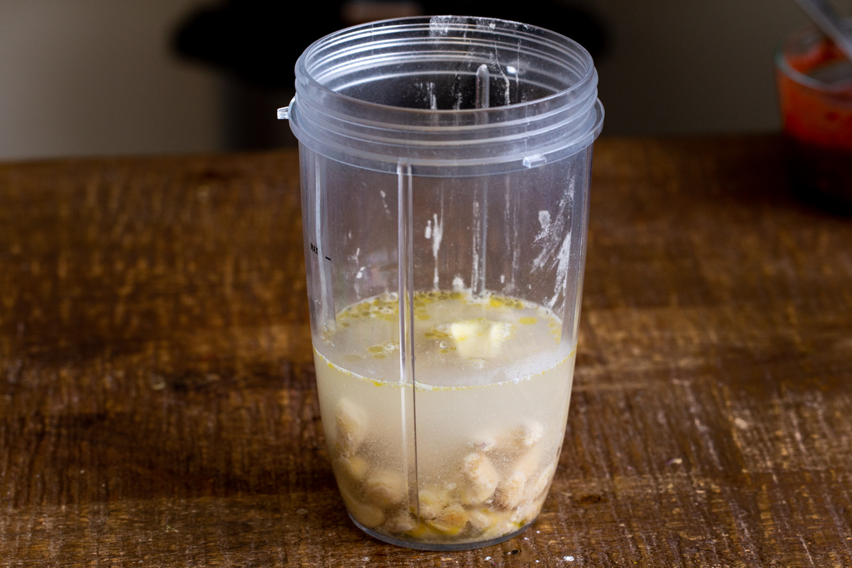 ingredients for vegan mozzarella cheese sauce in a measuring cup