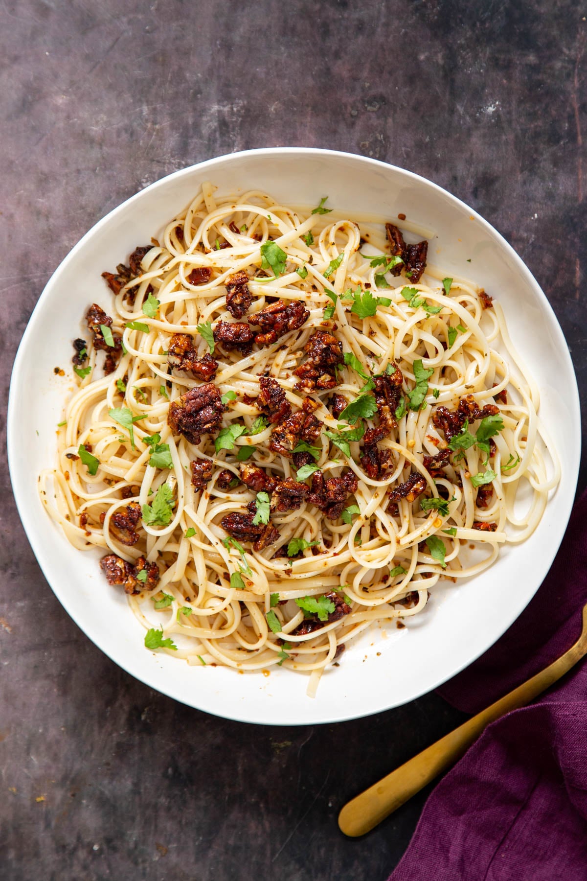 overhead shot of a serving of pasta topped with smoky pecans
