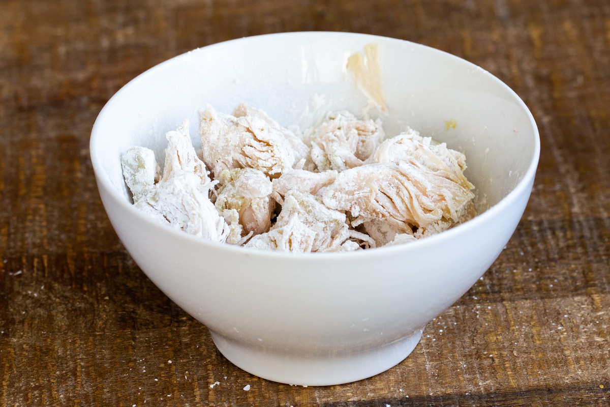 jackfruit tossed with cornstarch in a small white bowl