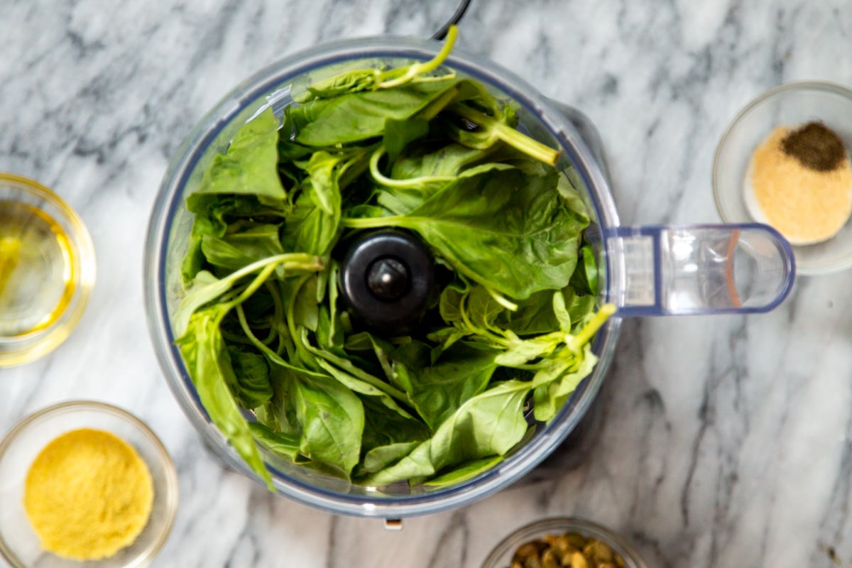 fresh basil leaves in a food processor