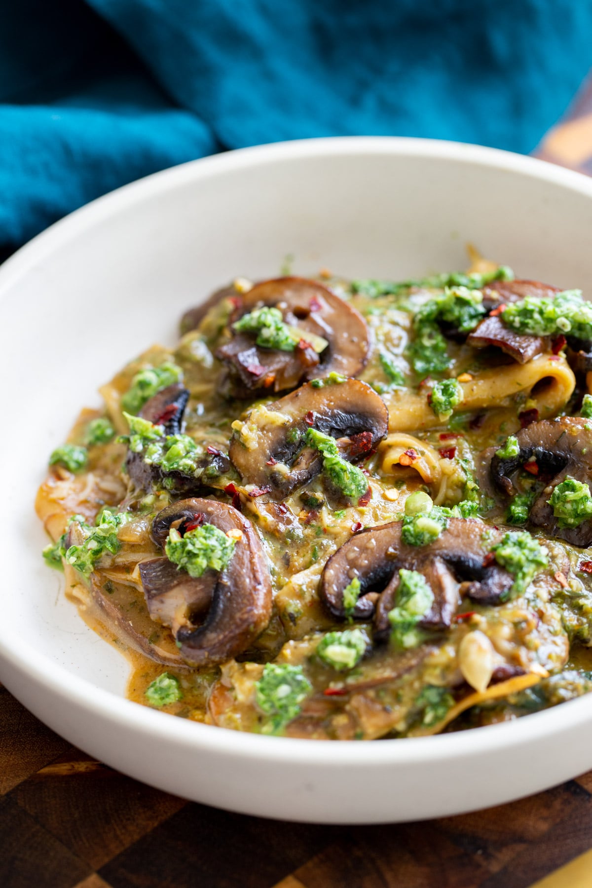 vegan mushroom pesto skillet lasagna served with dollops of basil pesto in a white bowl