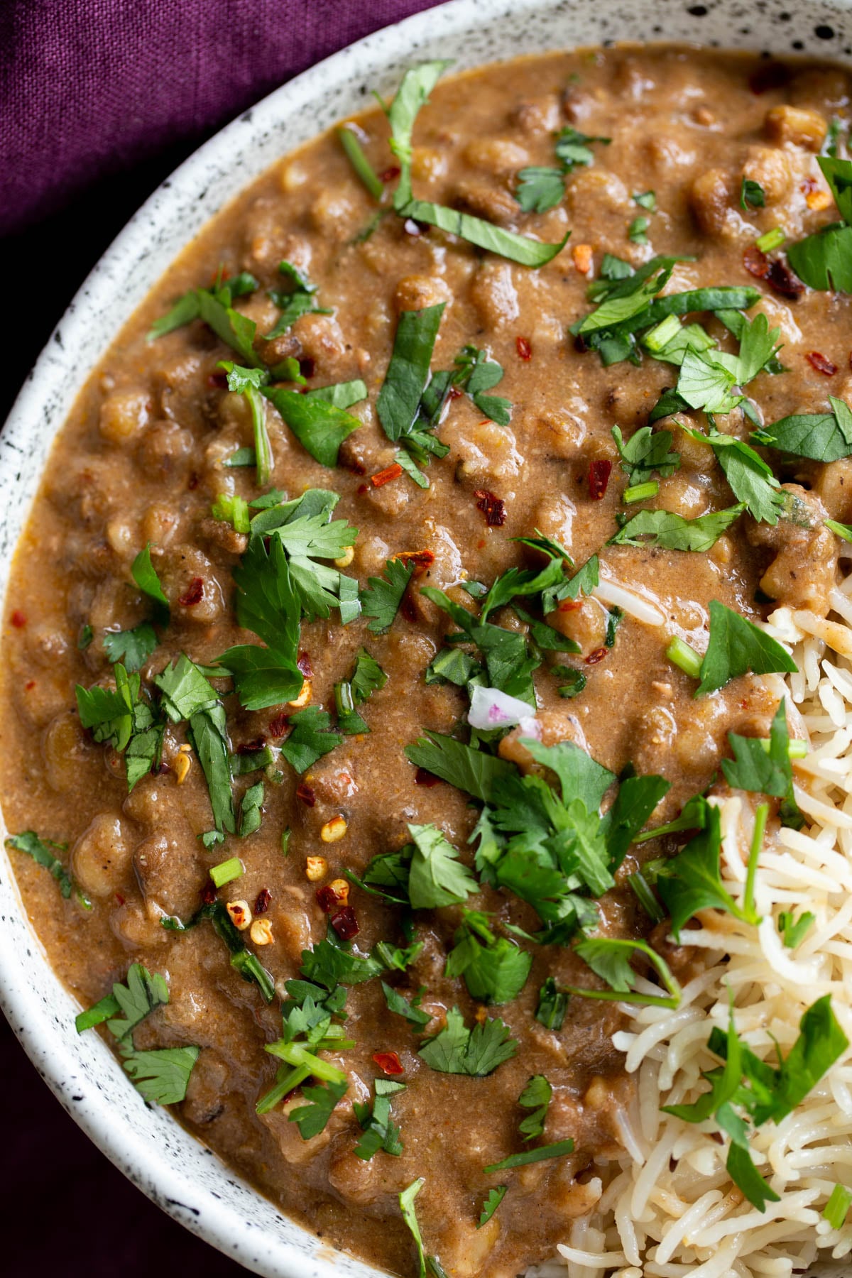 overhead shot of a serving of green mung bean curry served with rice 