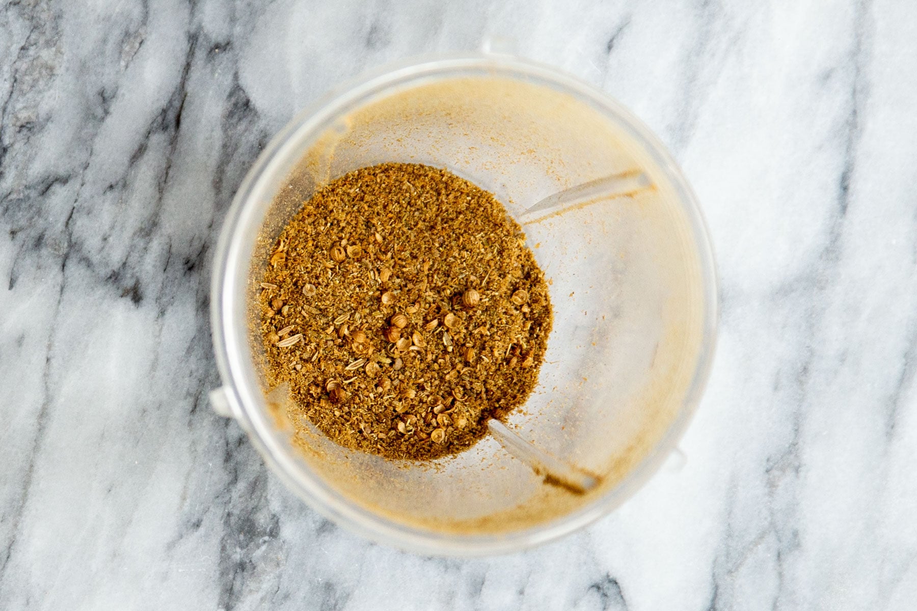 ground coriander and fennel seeds in a grinder