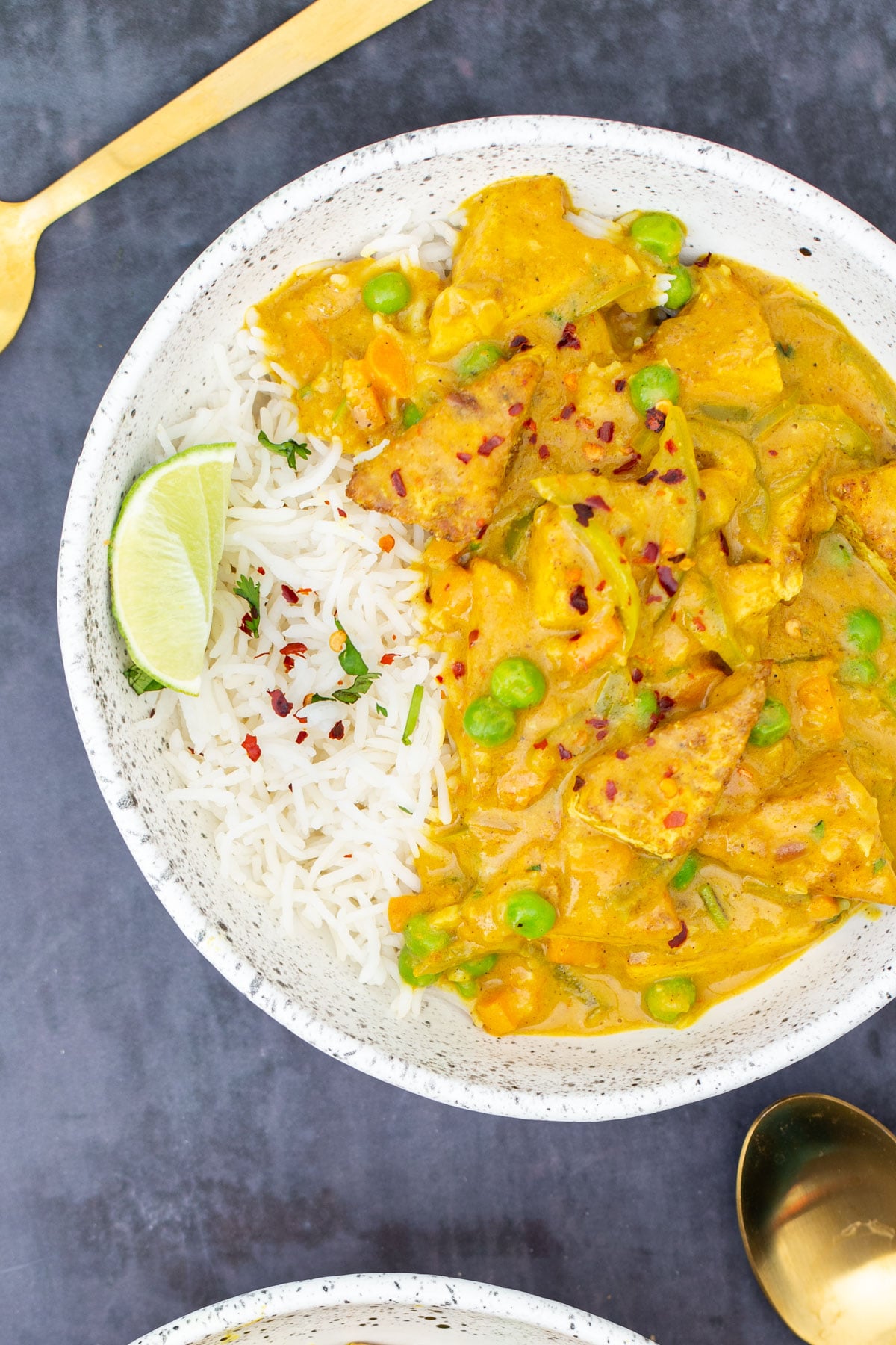 malaysian coconut curry with crispy tofu served with a side of rice 