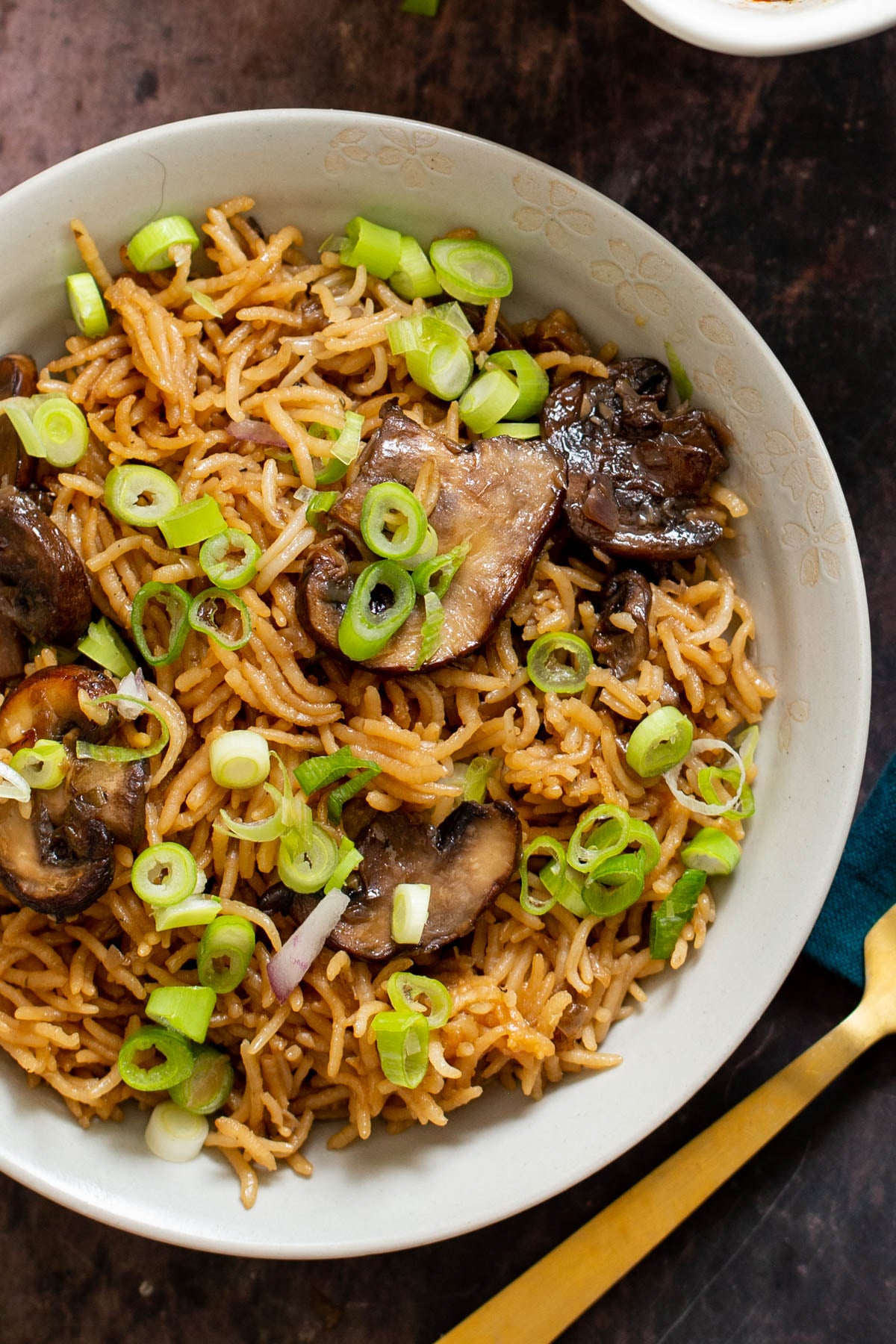 a serving of fluffy baked vegan mushroom rice sprinkled with green onion 