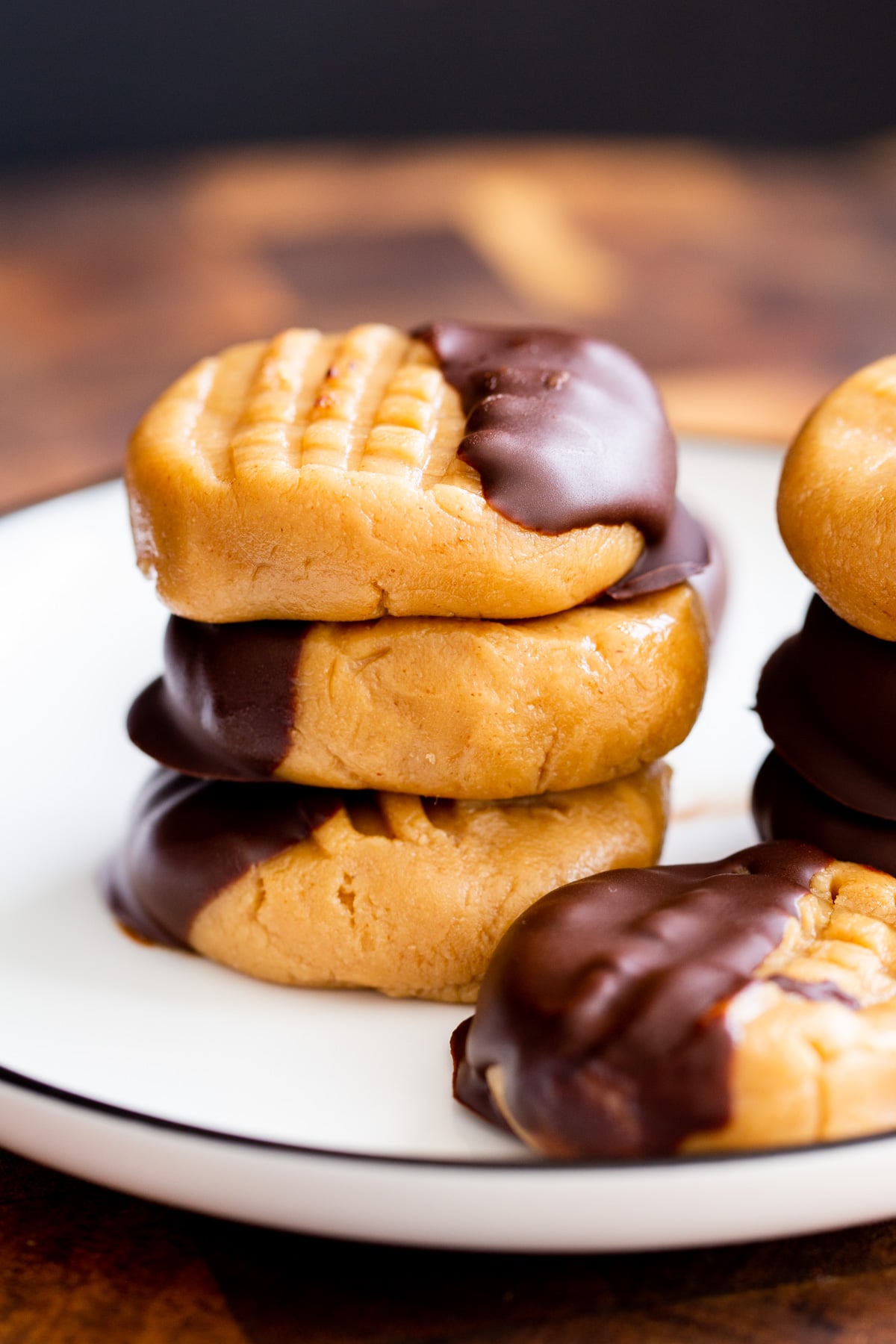 a stack of no bake peanut butter cookies dipped in chocolate on a plate