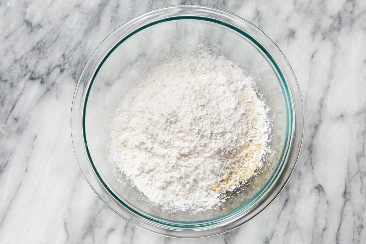 dry ingredients for making vegan almond joy cookies in a glass bowl