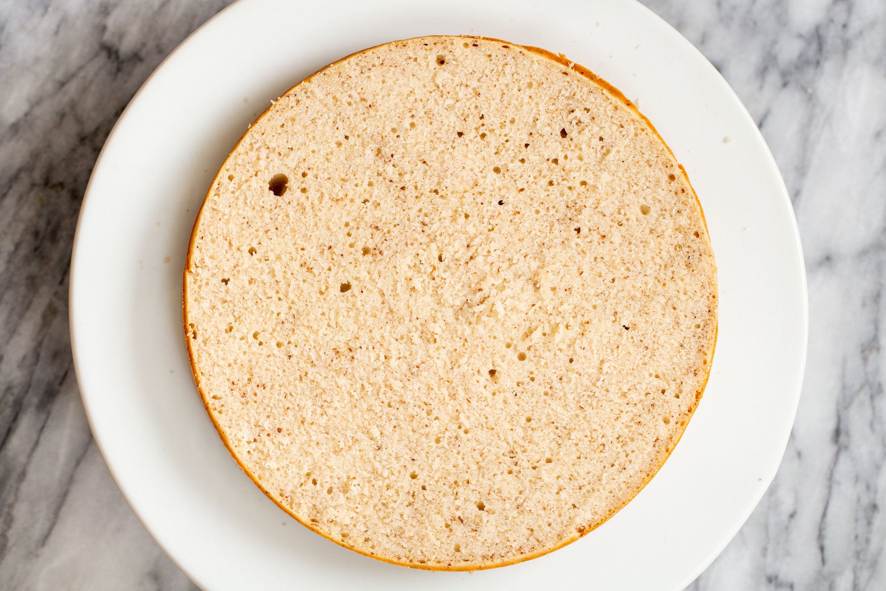 sliced open sponge cake on a cake stand