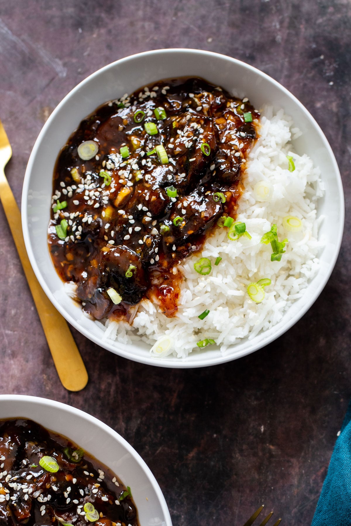 sticky sesame mushrooms served with rice and sprinkled with sesame seeds and green onions 