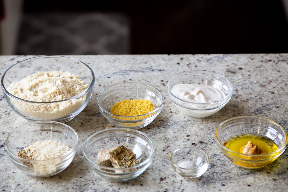 ingredients for making vegan cheese balls on a concrete countertop