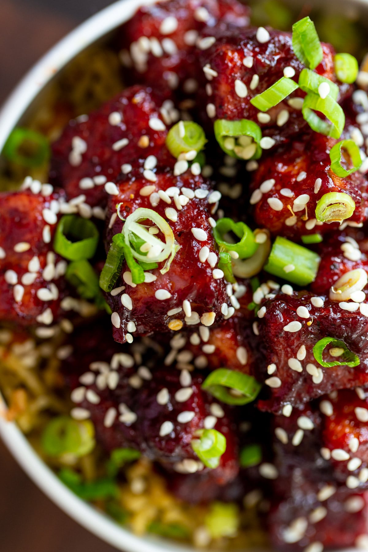 overhead shot of blackberry gochujang sprinkled with sesame seeds and chopped green onions