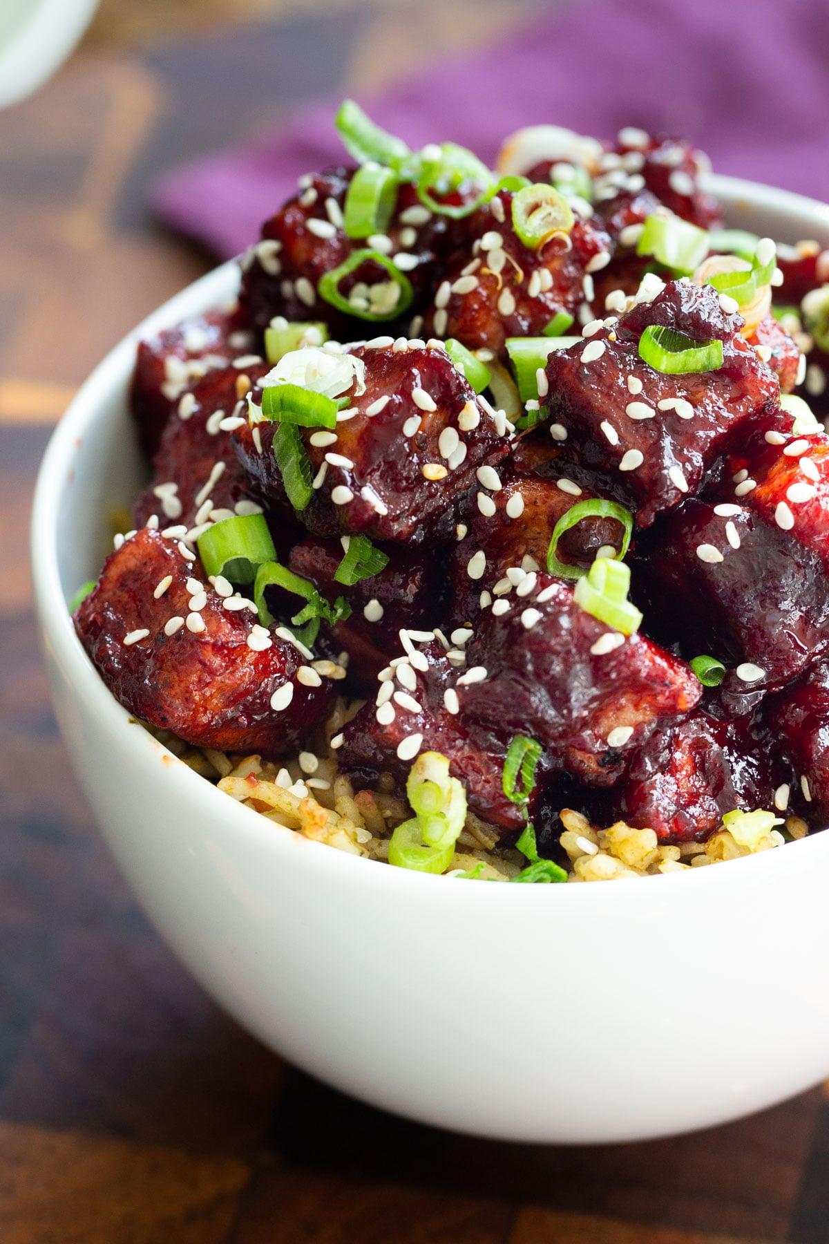 a bowl of blackberry gochujang tofu served over rice