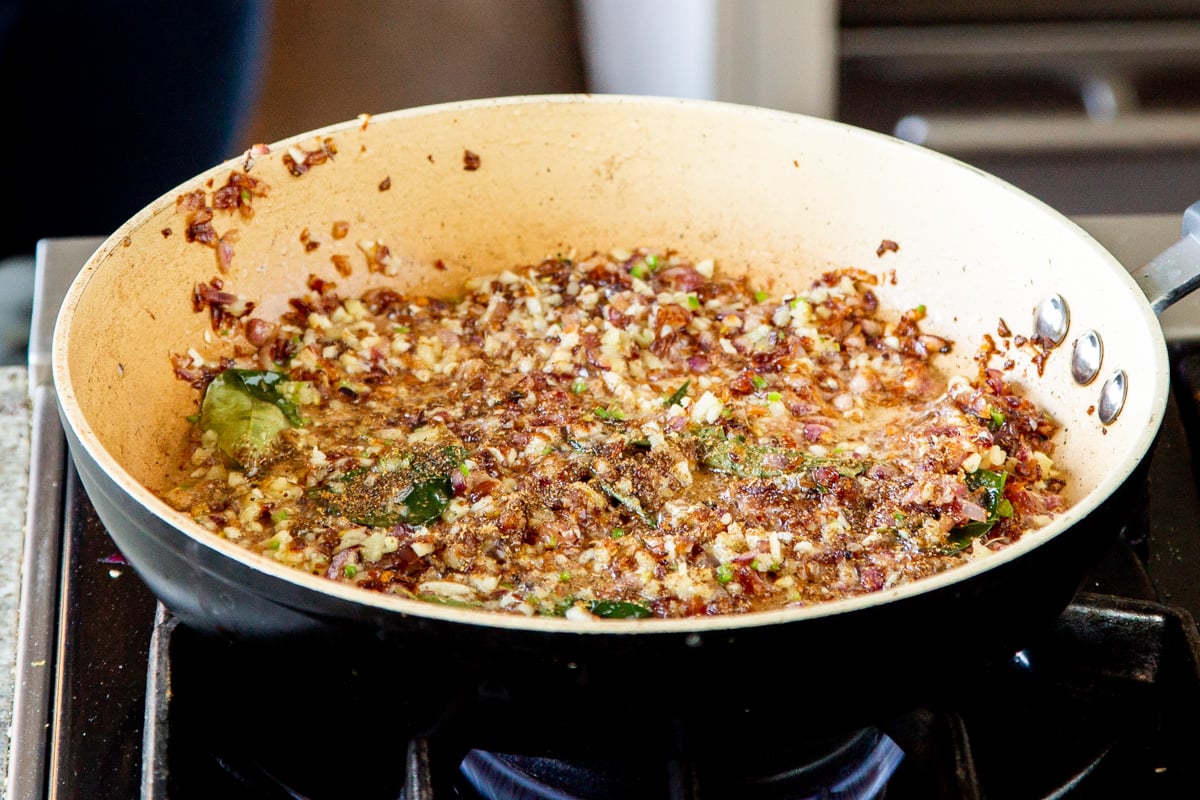 onion and chili in a sauteeing pan