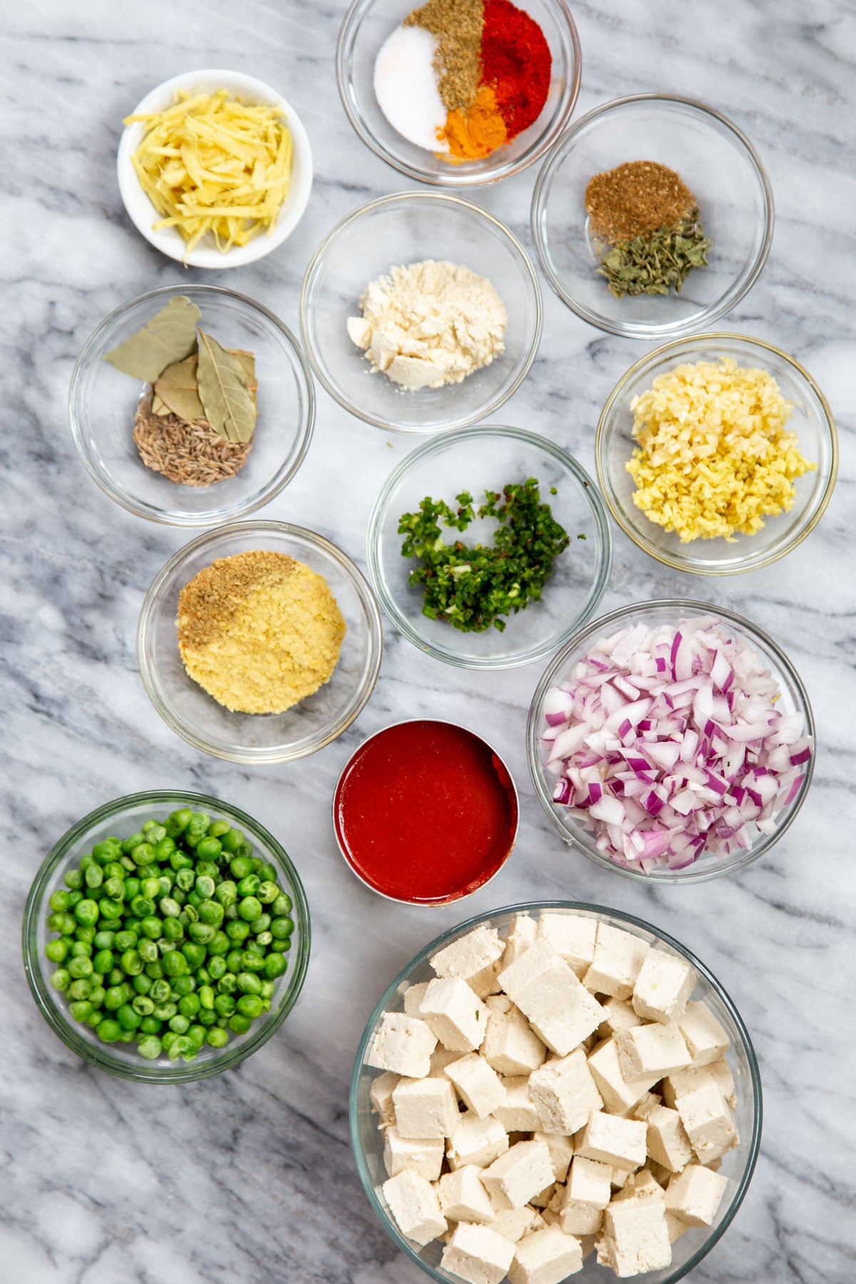 ingredients for making matar tofu on a marble countertop