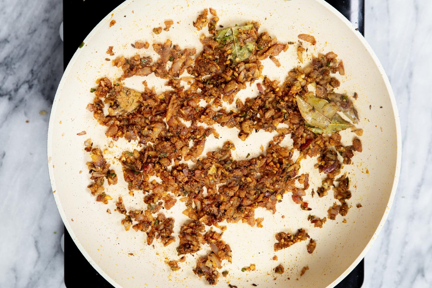 ginger and spices in a sauteein pan