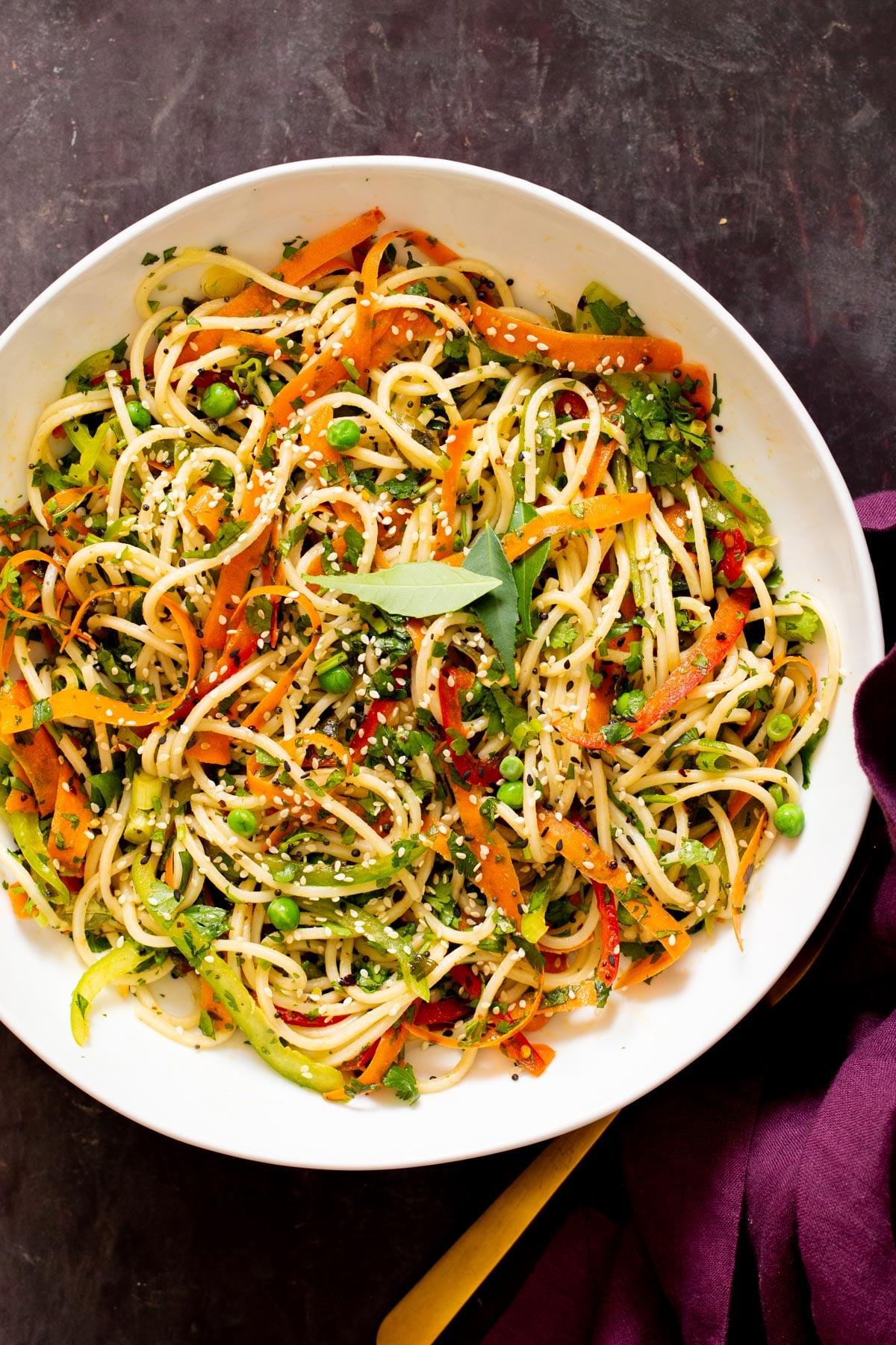 mustard chili oil pasta salad in a bowl sprinkled with sesame seeds
