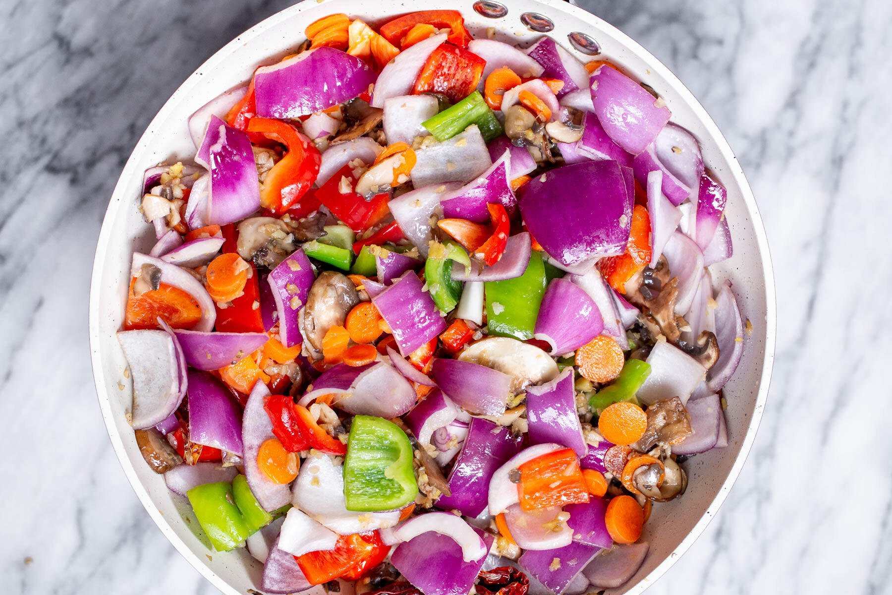 chopped veggies frying in a pan