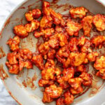 cauliflower tossed in gochujang sauce in the pan