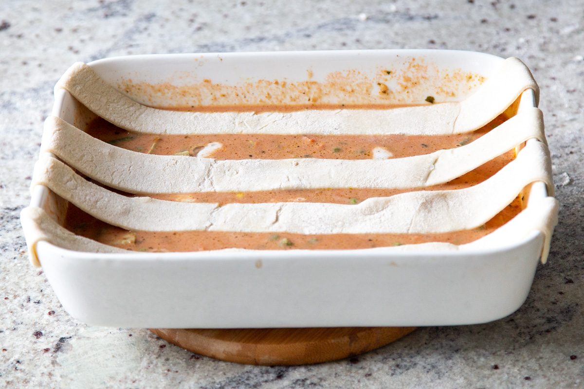 strips of puff pastry laid horizontally across the baking pan