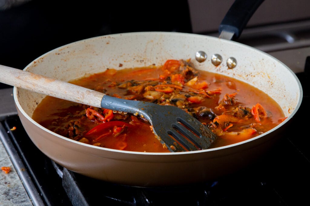 veggies and harissa sauce mixture in the pan, after cooking
