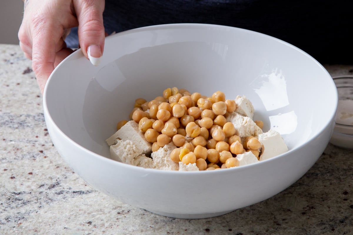 torn tofu and chickpeas in a bowl