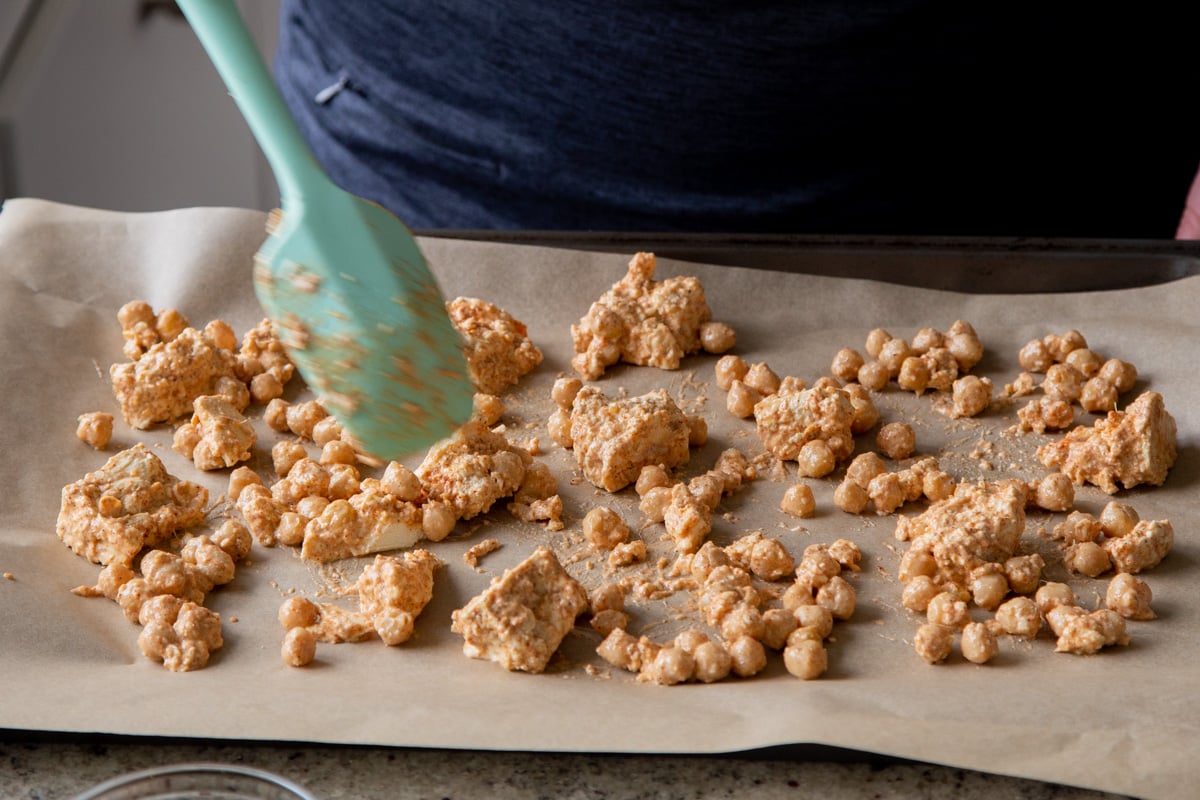 sauced chickpeas and tofu on the baking sheet before baking