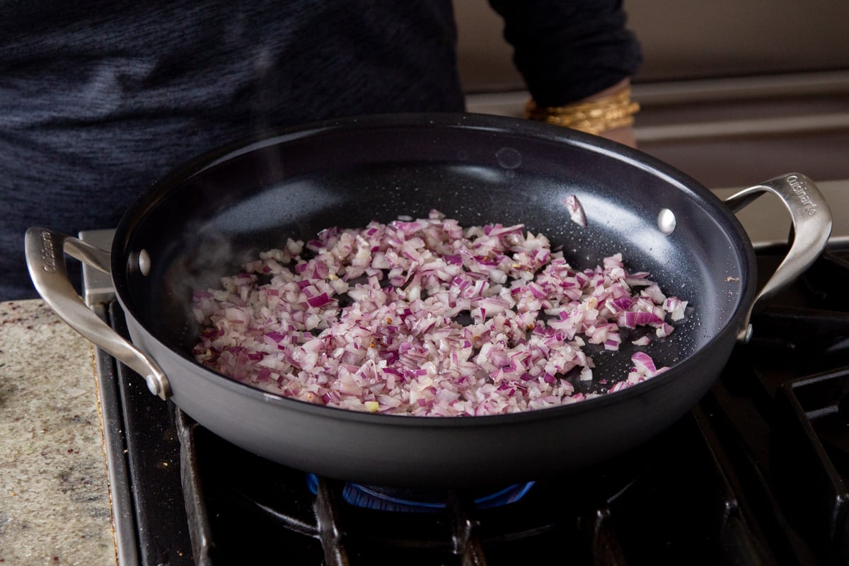 adding onions to the pan
