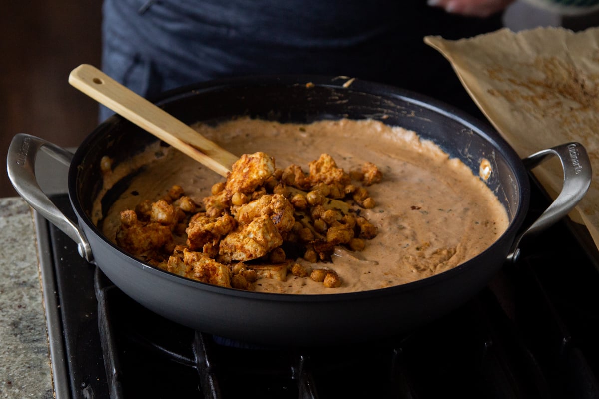 adding the proteins to the cooked curry sauce