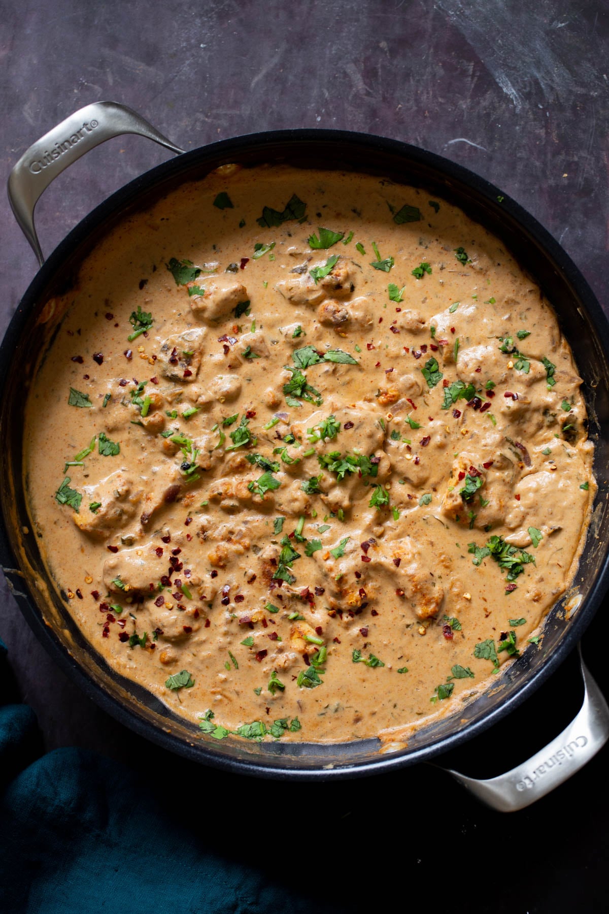 vegan kasuri malai murg in the pan, after cooking with fresh herbs sprinkled on top