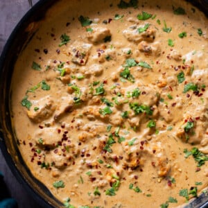 vegan kasuri malai murg in the pan, after cooking with fresh herbs sprinkled on top