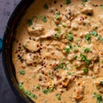 vegan kasuri malai murg in the pan, after cooking with fresh herbs sprinkled on top
