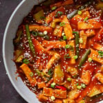 gochujang tofu stir fry in the pan topped with sesame seeds and green onion