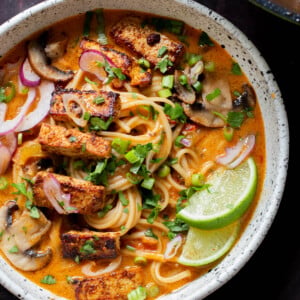 bowl of butter ramen with tofu and a lime wedge
