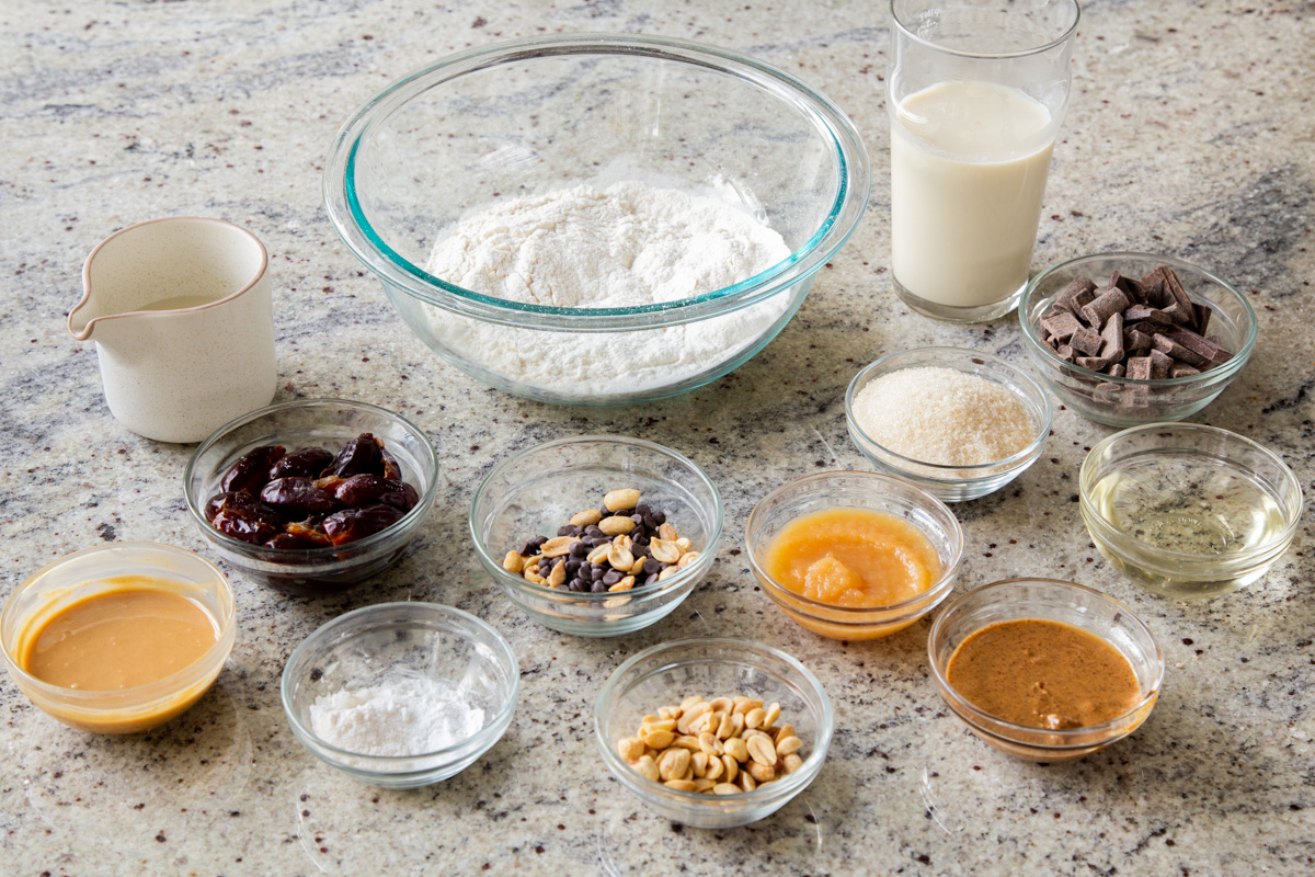 Snickers cake ingredients in bowls on a kitchen countertop