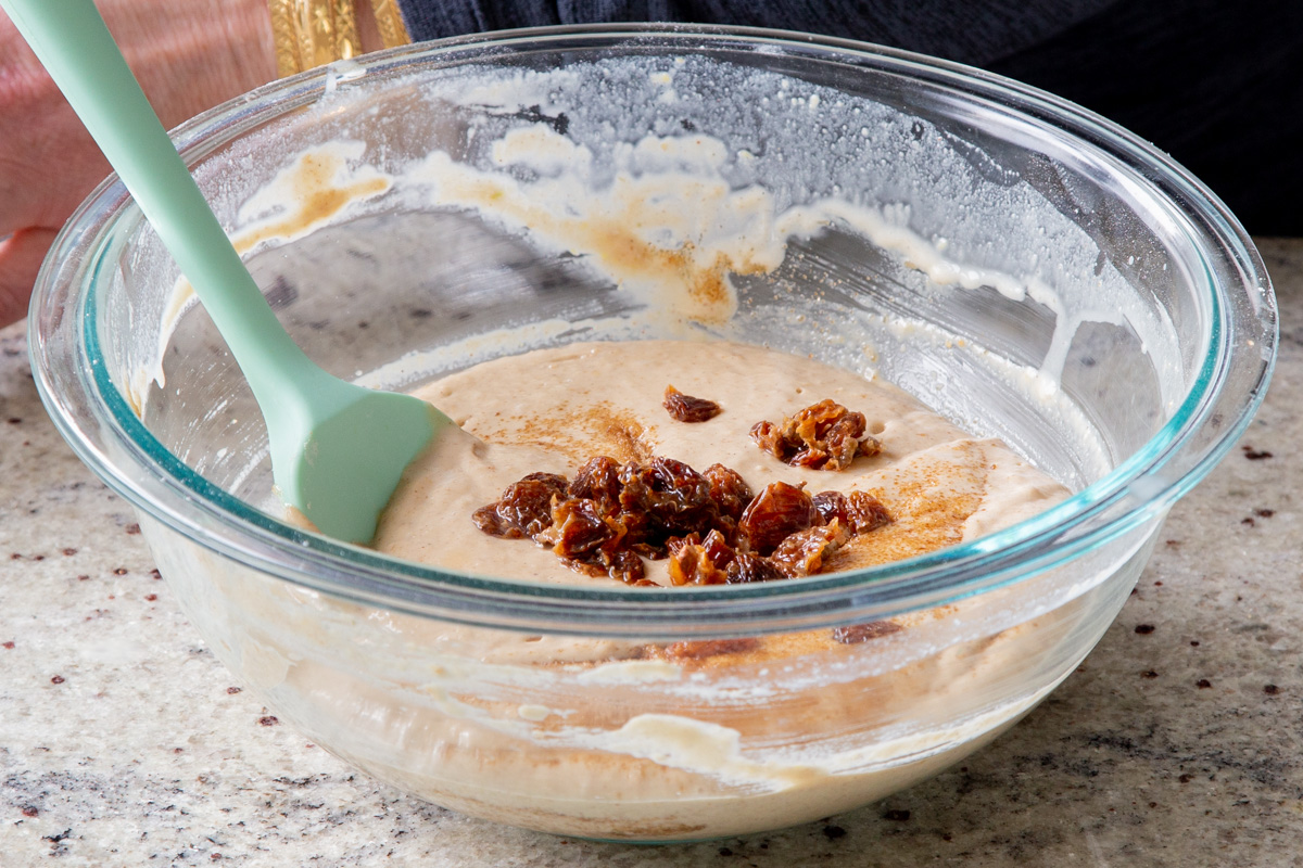 adding the raisins to the cake batter