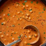 butter chickpeas in the skillet topped with cilantro